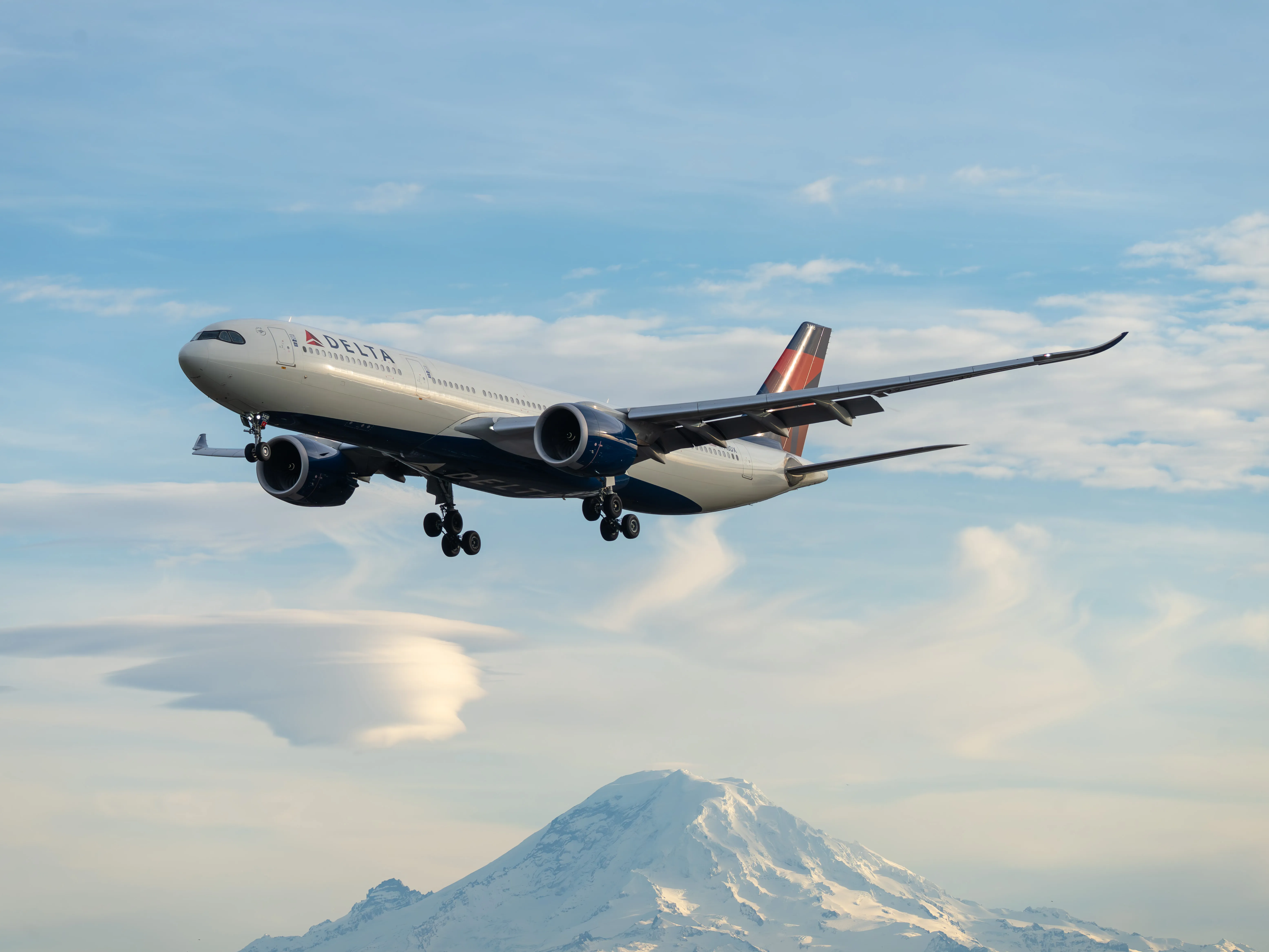 An Airbus A330-941 making final appraoch to Seattle-Tacoma International Airport, with Mount Rainier in the background
