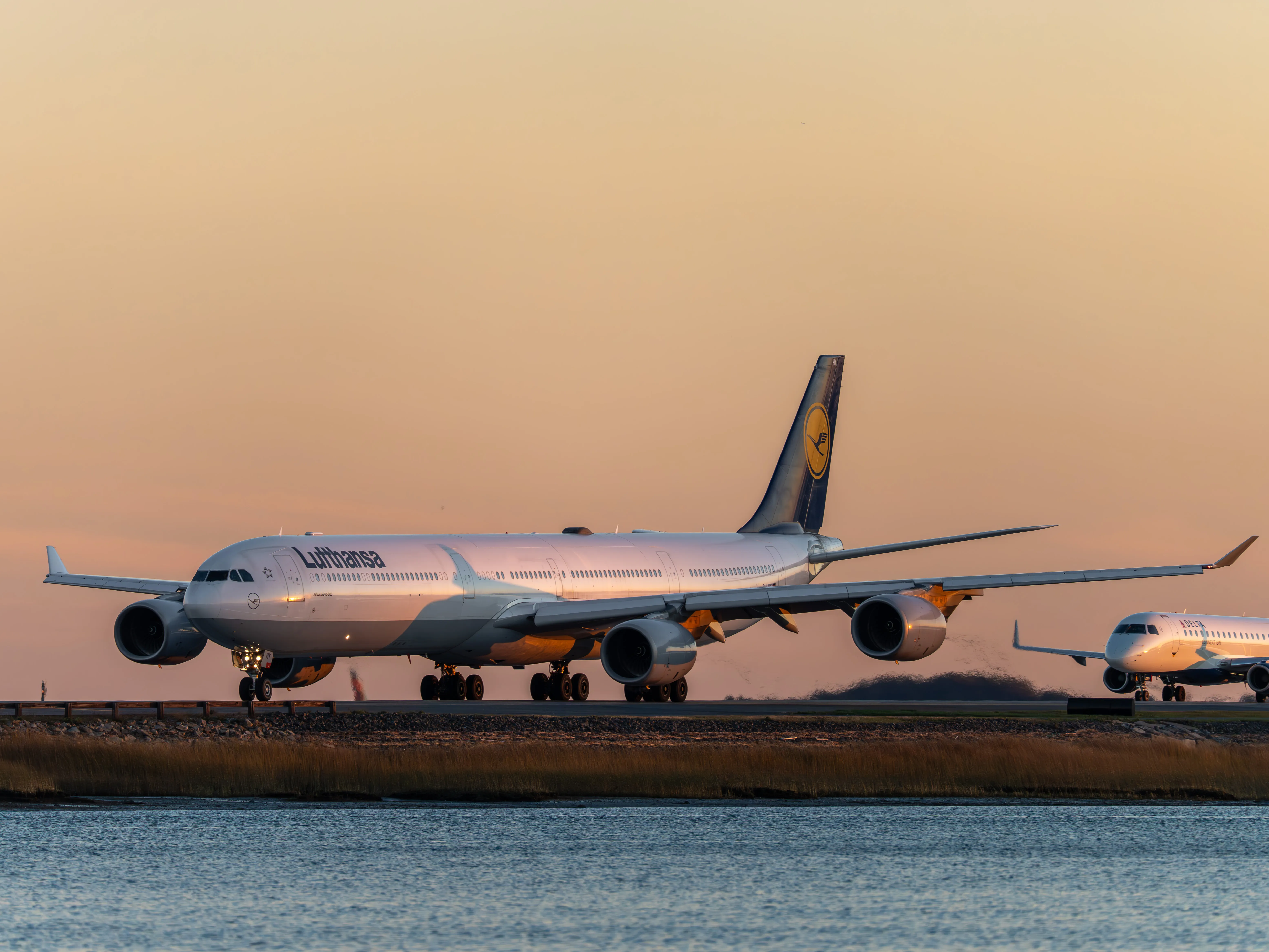Lufthansa Airbus A340-642 taxiing during sunset at Boston Logan International Airport